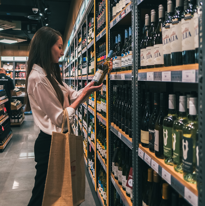 Woman in a liquor store shopping for wine taken at town