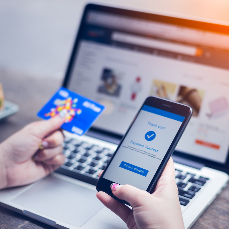 Online shopping concept young woman hands holding mobile smart phone showing payment success on